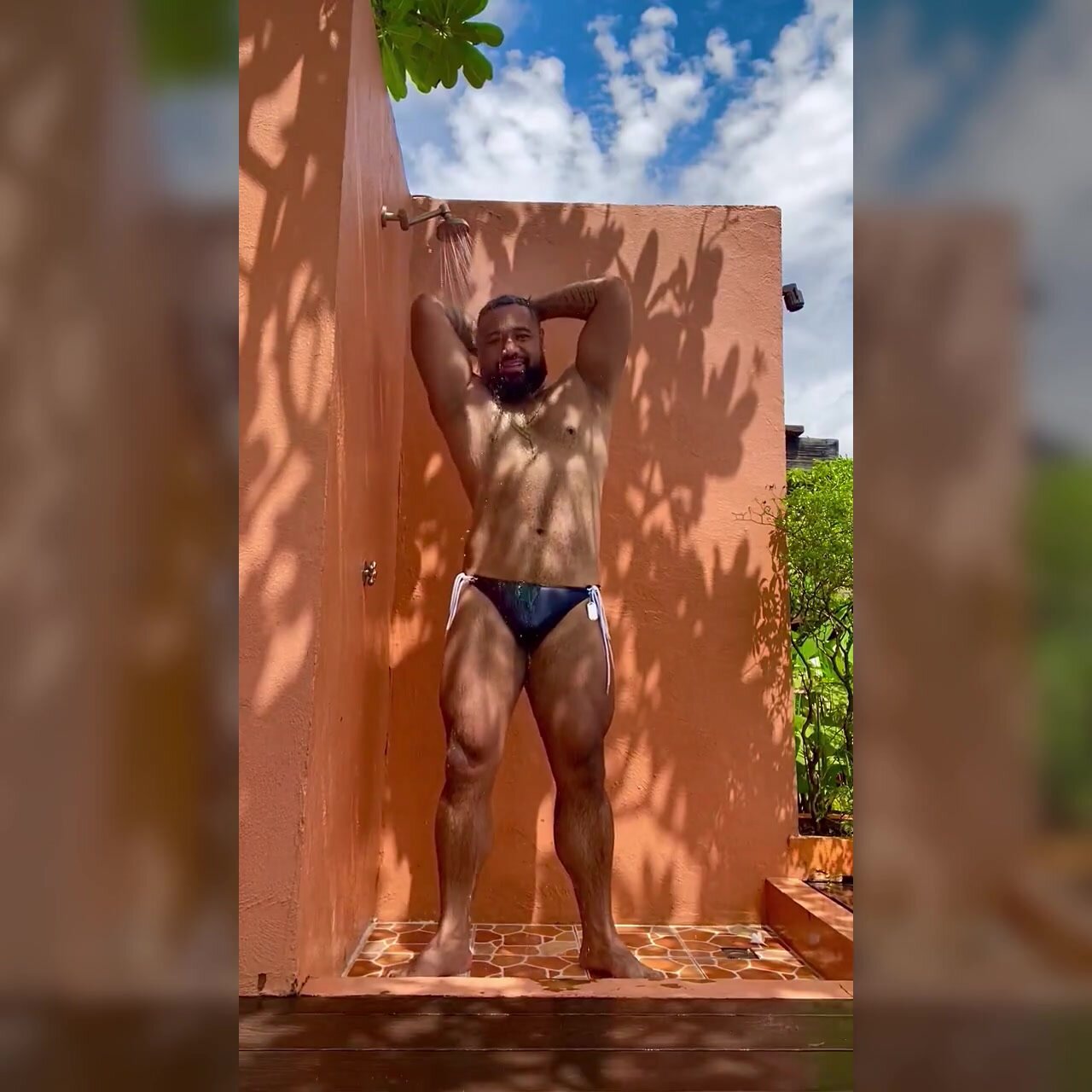 Gorgeous muscle bear showers outdoors