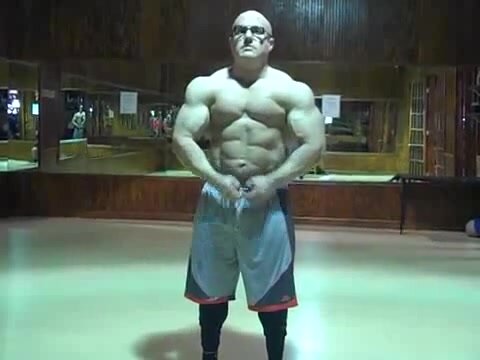 Musclebull with glasses flexing