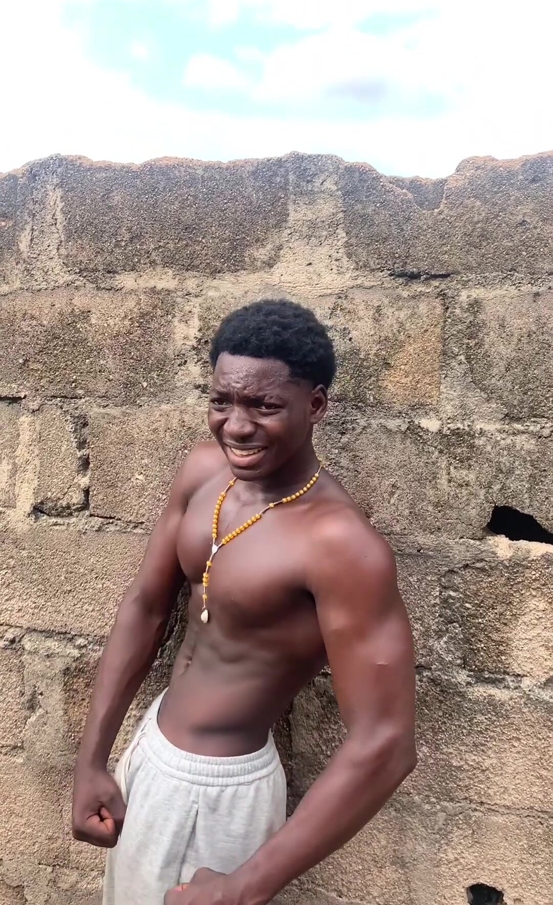 Young black african posing muscles