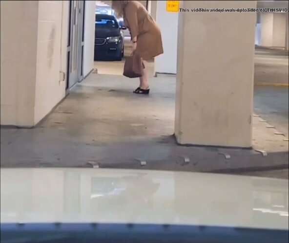 Woman peeing in front of the door