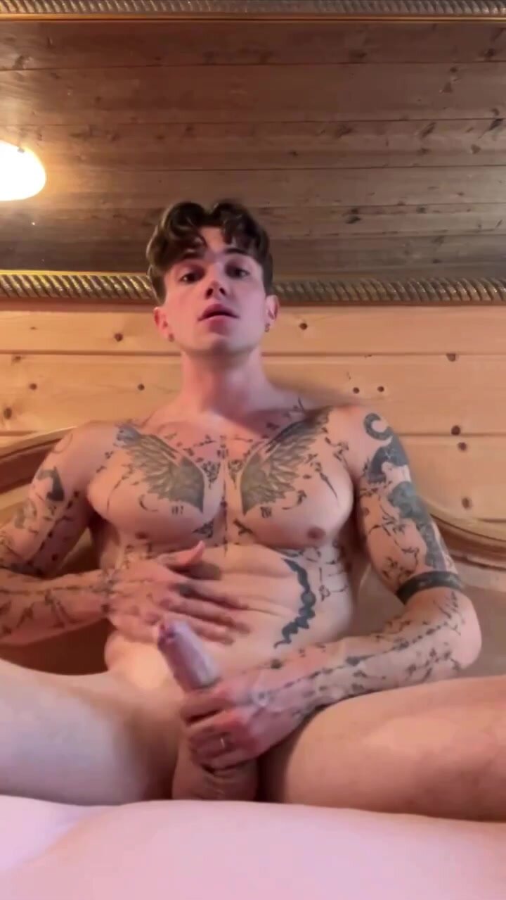 tattoed boy stroking huge cock