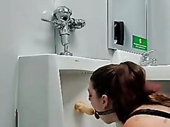 Sucking dildo at urinal