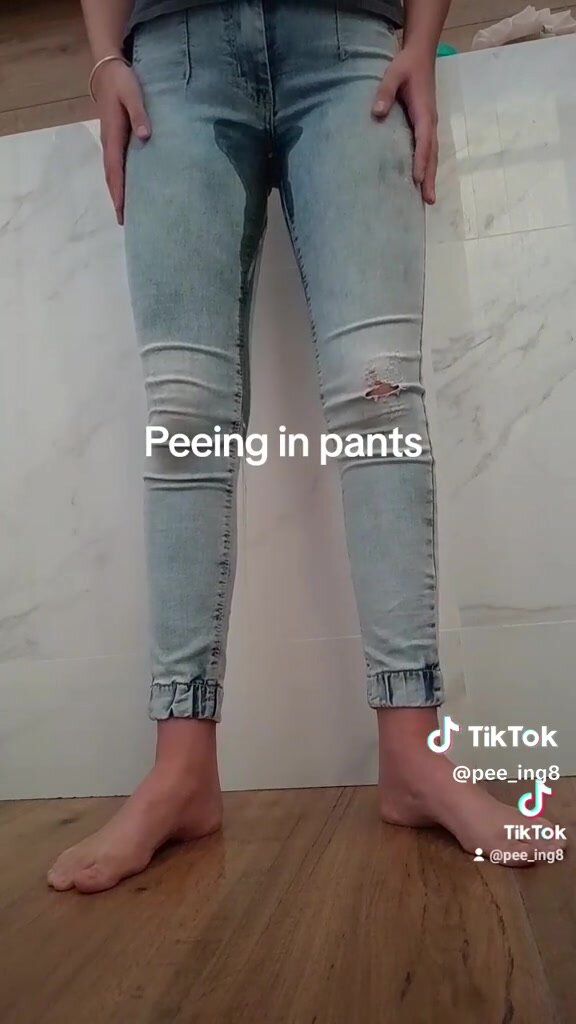 girl pees light cut-knee jeans