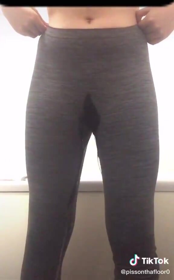 girl pees dark gray leggings