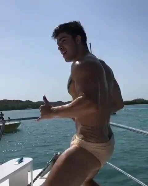 Sexy young guy dancing on yacht