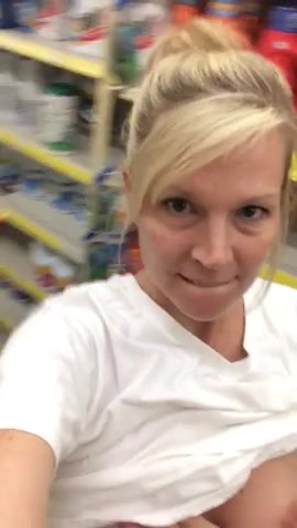 Blonde cougar shows her boobs at the store
