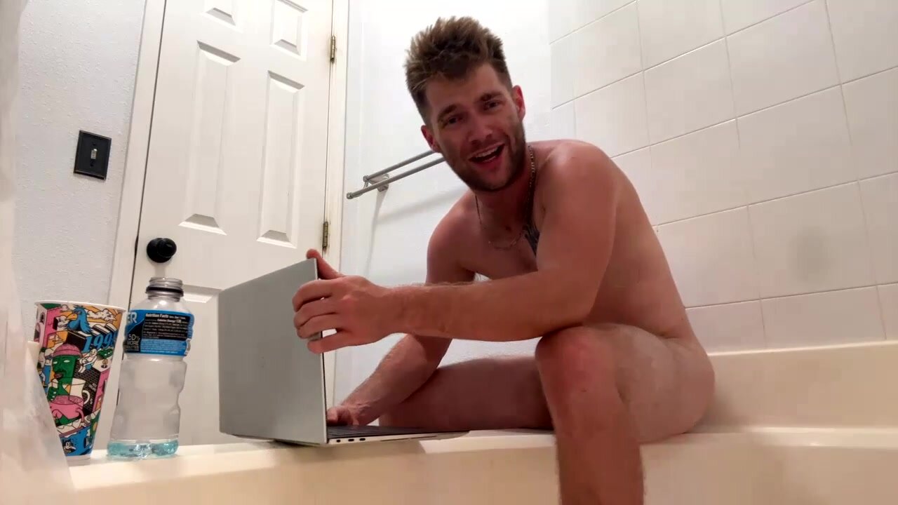 playful dude plays with dildo in the bath
