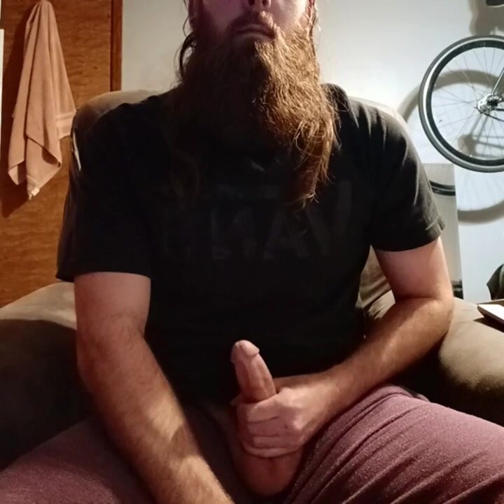 Bearded guy strokes out cock