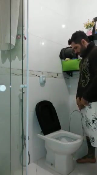Guy pissing in the bathroom