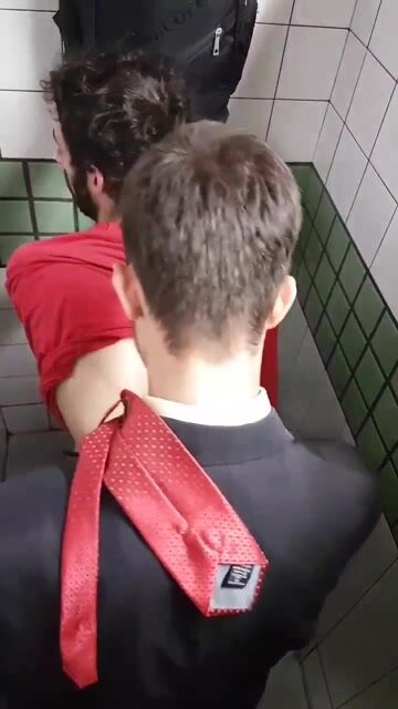 Man in a suit fucking man in sportswear in stall public