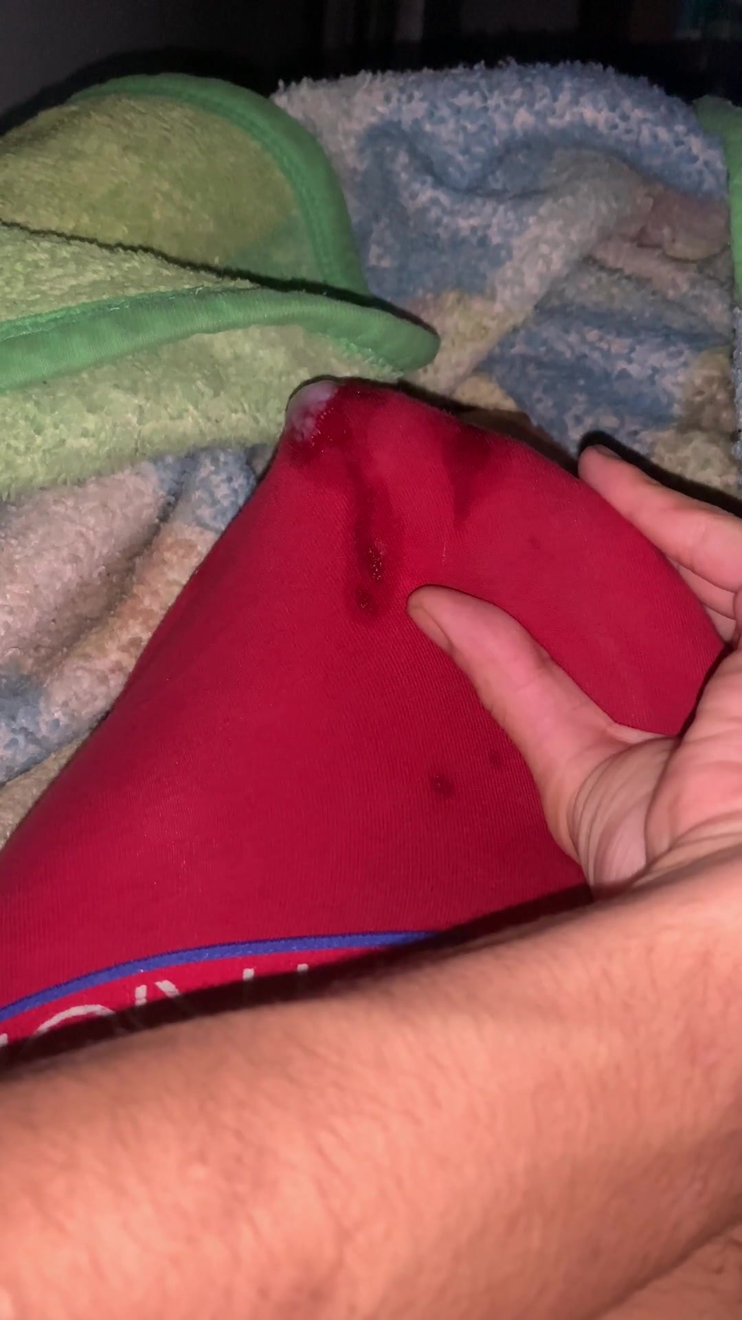 Jerking twink soddens red underwear with cum
