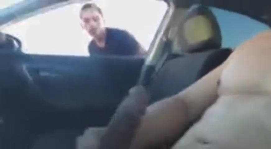 Boy climbs into car to service daddy