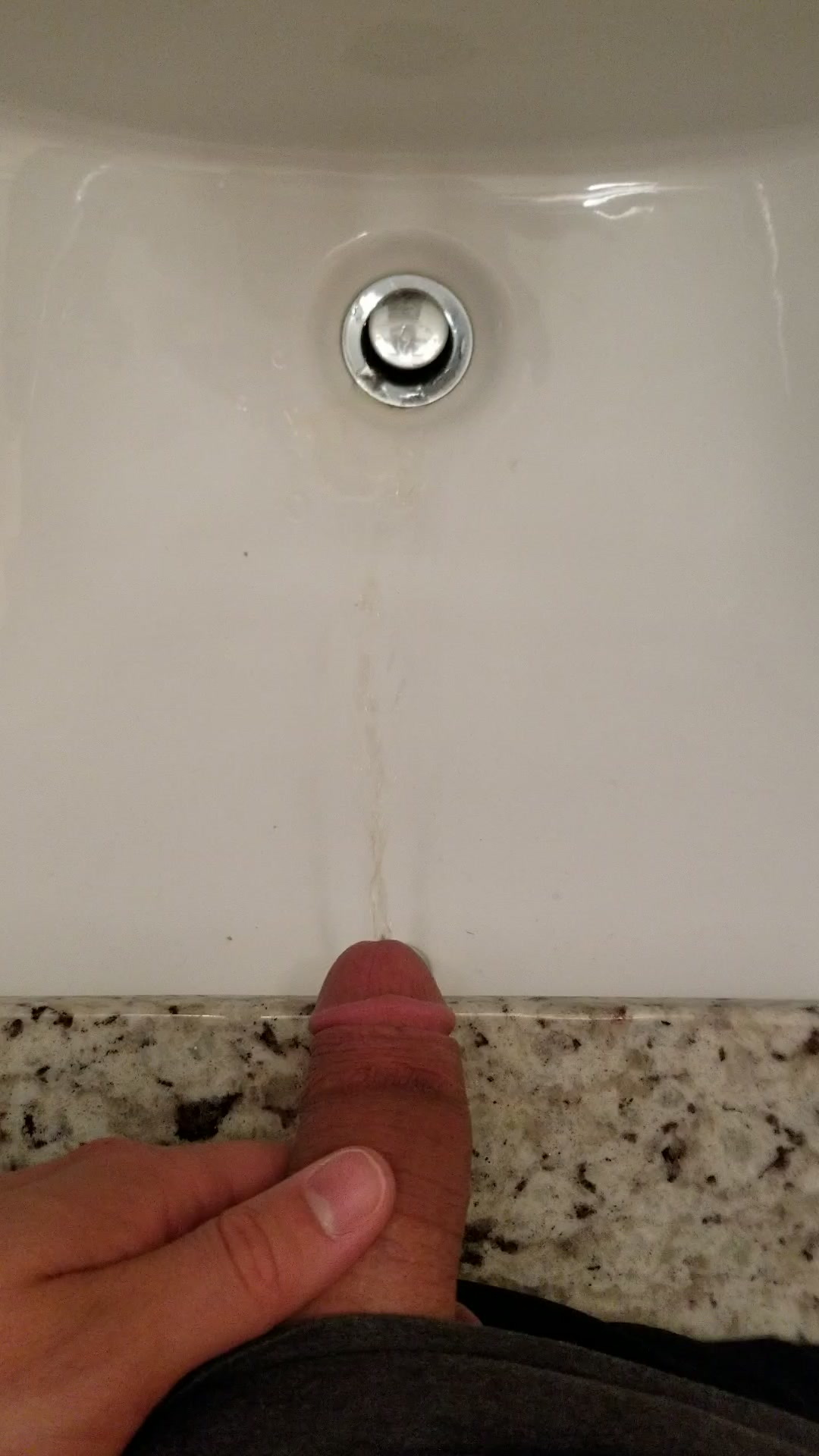 Boy pissing in sink