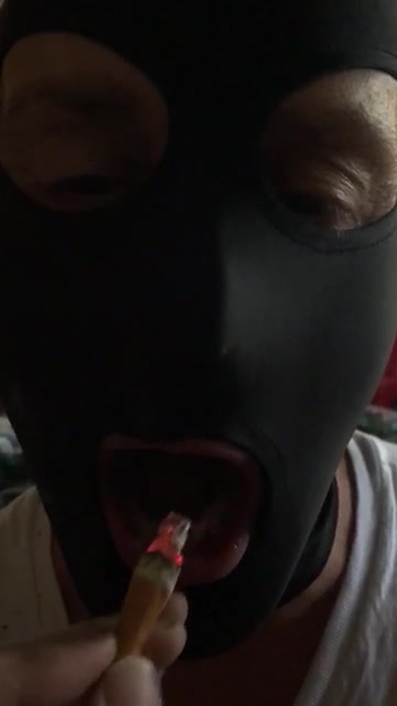 Ashtray boi putting out a cigarette bud on his tongue - video 2