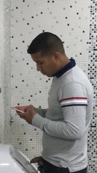 TEXTING AND PISSING AT THE URINAL