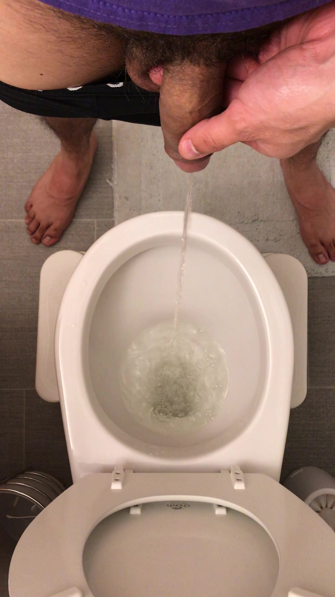 Girl sitting on toilet pissing on mans dick