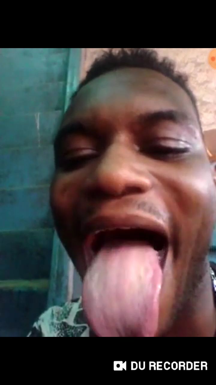 African guy shows his big tongue