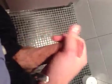 Suited pig gets handjob in a stall