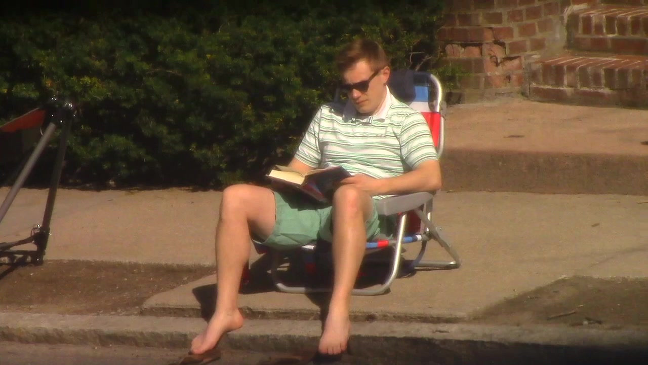 Candid Barefoot - Neighbor Reading on Sidewalk