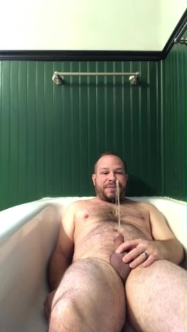 Man pissing on himself in the tub