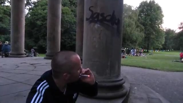 young guy smoking in park