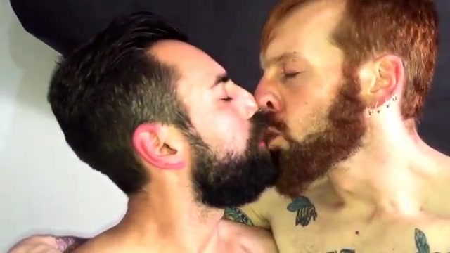 Men with beard kissing