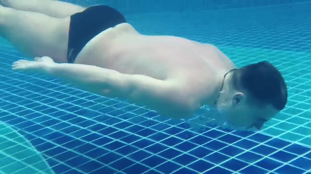 Man underwater in the pool