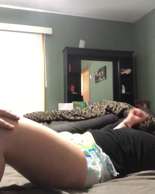 Girl in messy diaper gets bounced on her bed