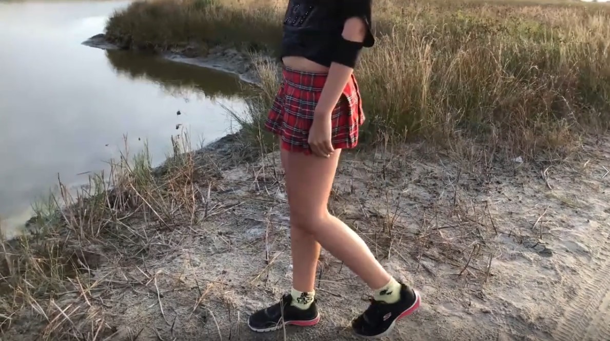 Schoolgirl peeing in public at a lake