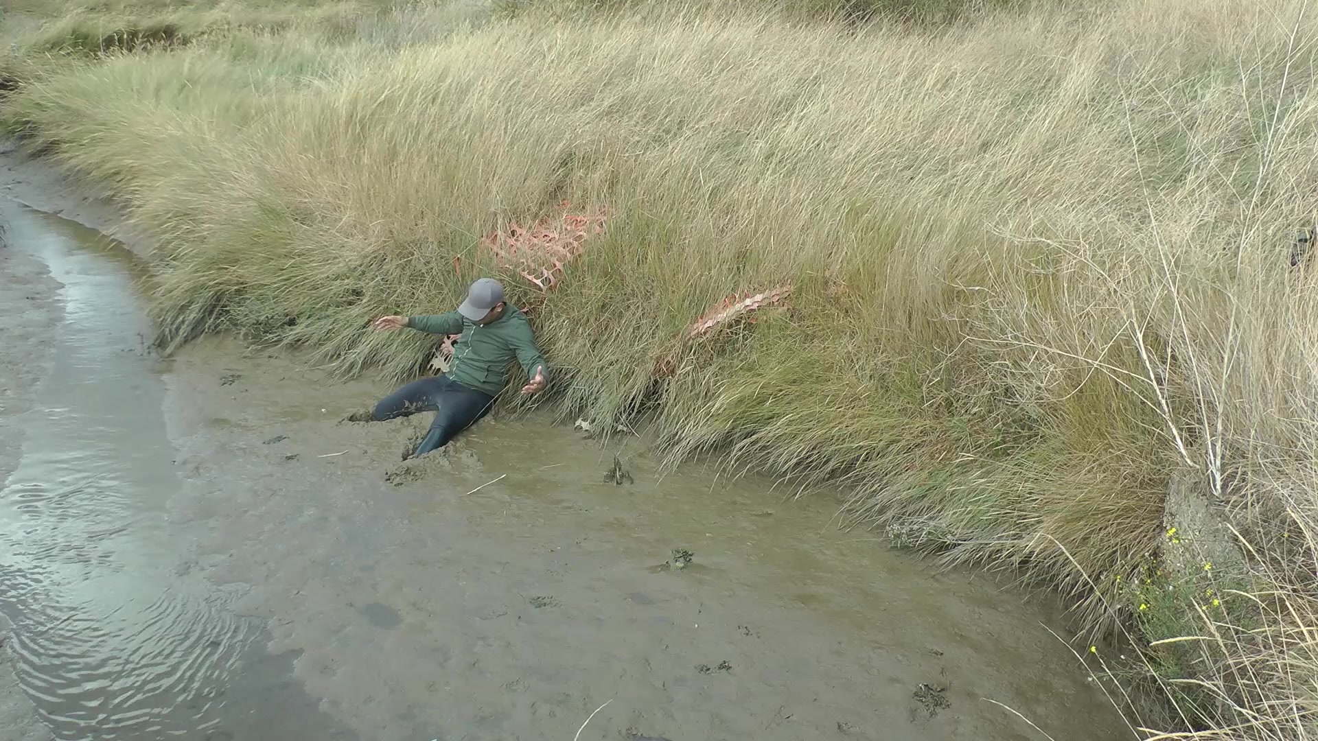 Humiliating muddy fall for booted man