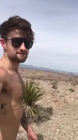 Lad briefly hikes naked on rocky beach