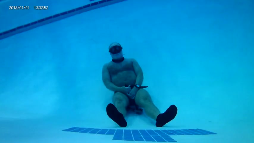 Hairy guy holding breath underwater for three minutes