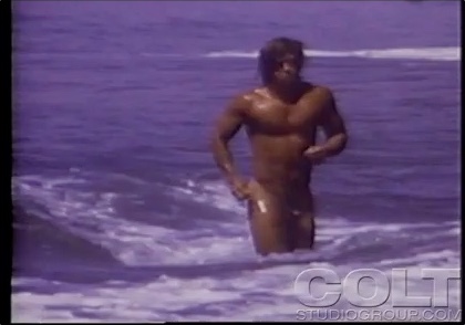 Vintage bodybuilder at beach
