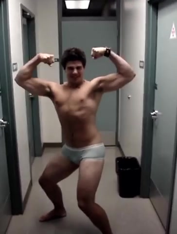 Muscle boy poses in kid’s underwear in front of his friends
