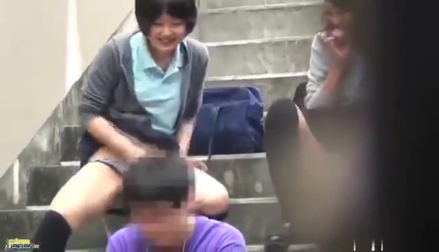 Japanese girls doing a sneak piss attack on a busy guy