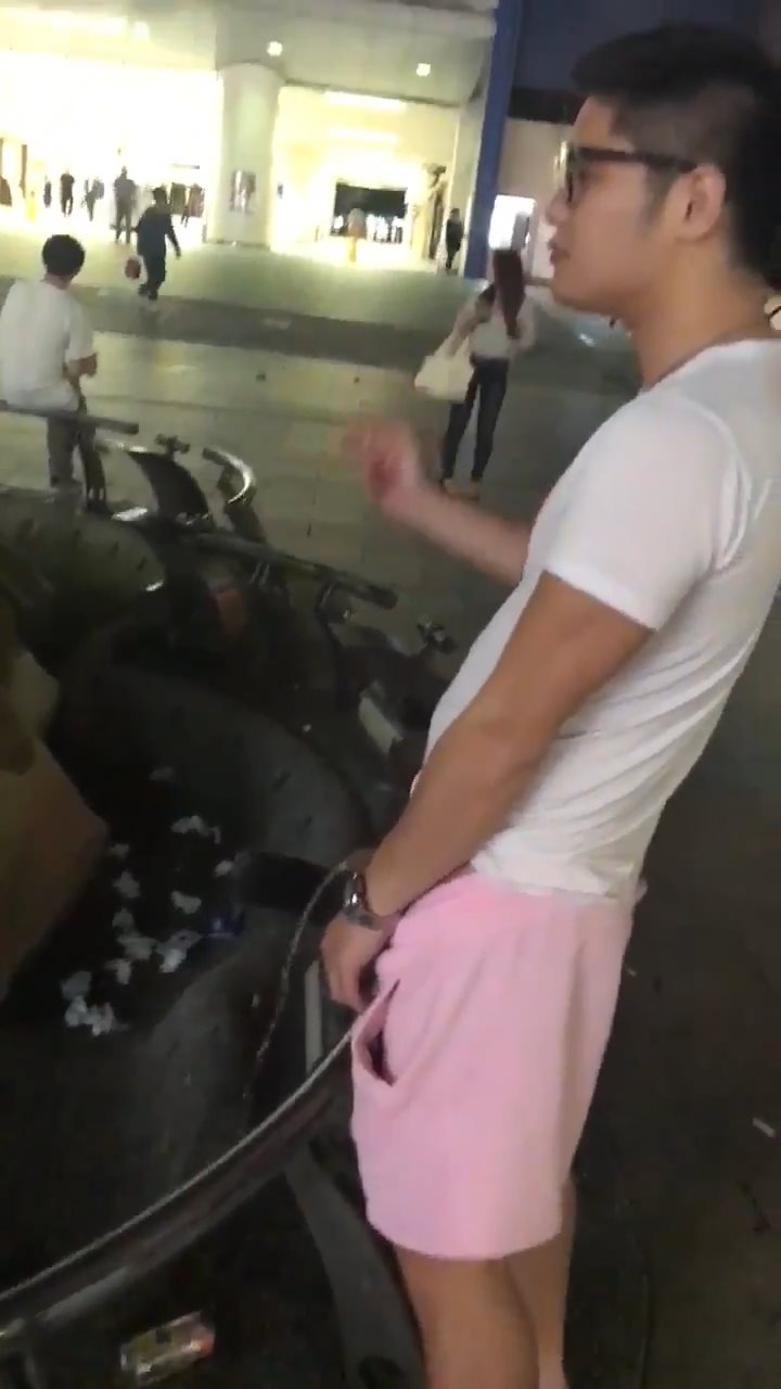 Japanese lad pissing outside a busy train station