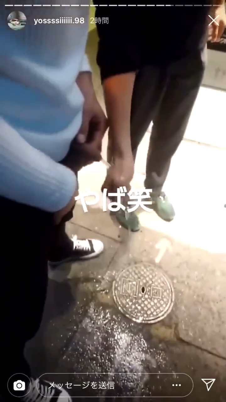 Japanese lad pissing on his friend's hand publicly