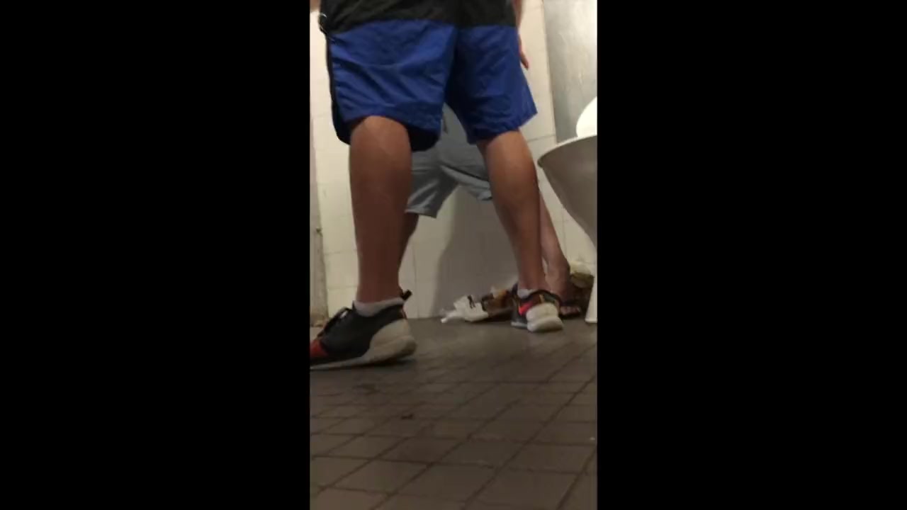 Two guys jerking in the stall