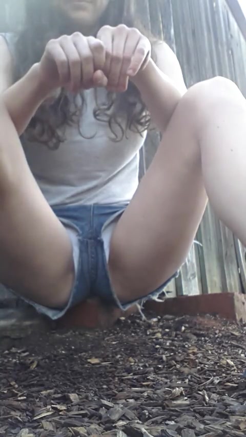 Pissing in her shorts outside