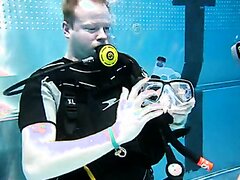 Beefy scubadivers removing mask underwater