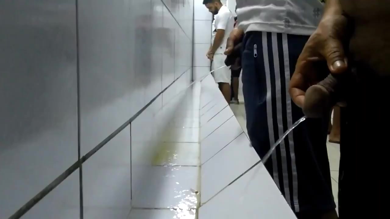 MANY GUYS PISSING AT THE URINAL