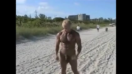 Mature bodybuilder on beach