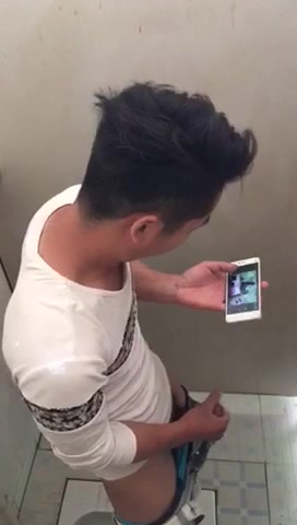 Asian guy jerking in toilet