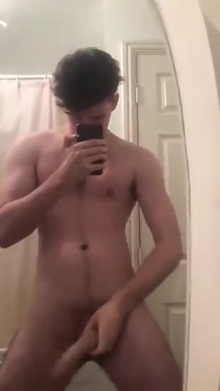 Guy swinging big cock in the mirror