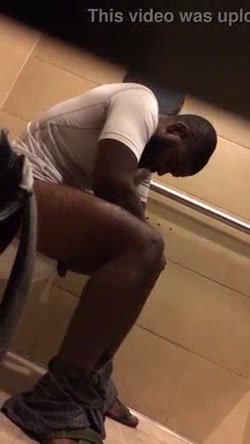 Black man on the toilet