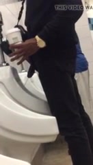 Black man at urinal spy