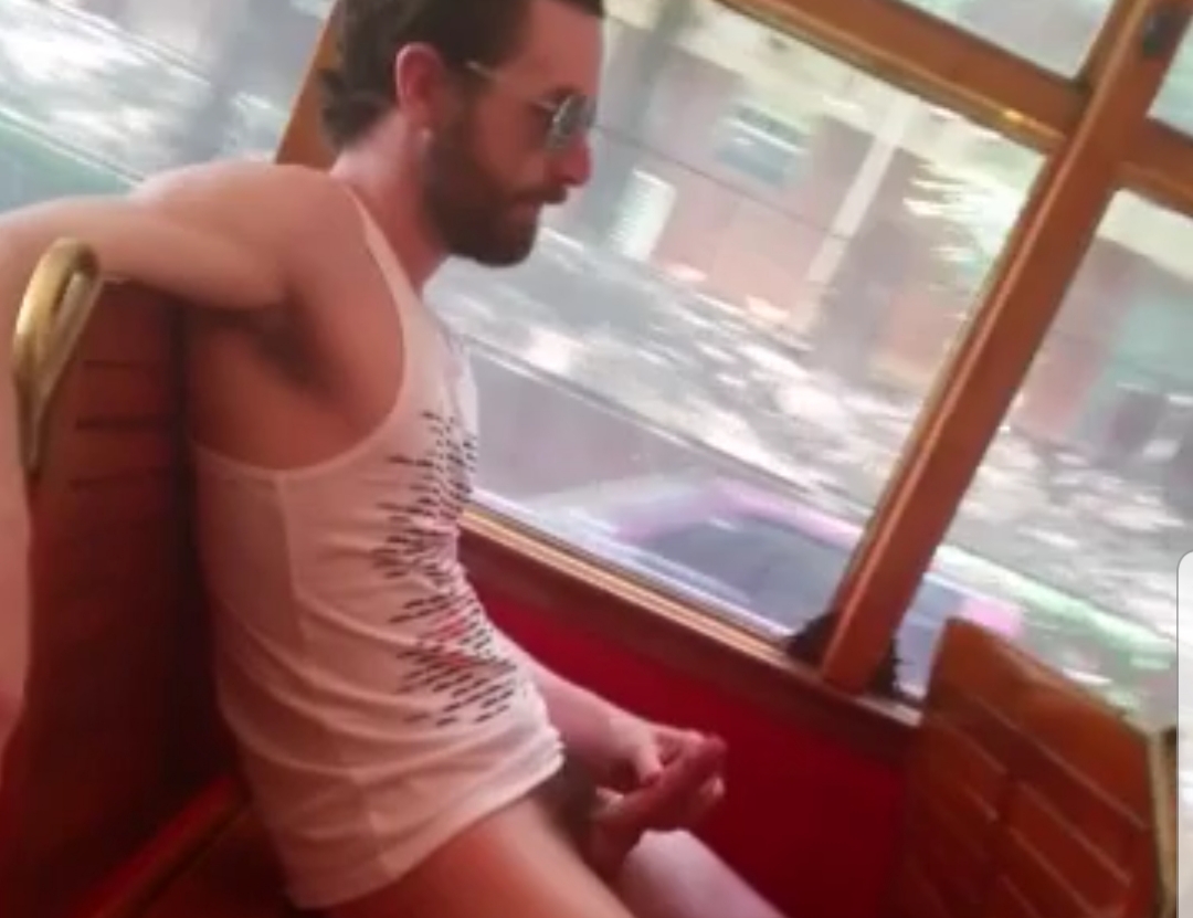 Hipster guy jerking on public trolley