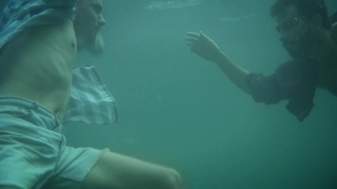 Clothed cuties swimming barefaced underwater