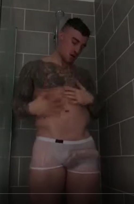 Muscular, tatted dude in shower