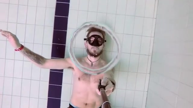 Freediver blowing air rings underwater